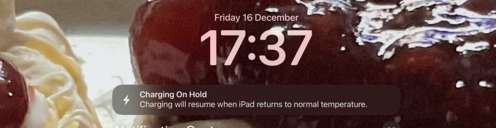 iPad screen reporting that charging is paused due to cold temperature.