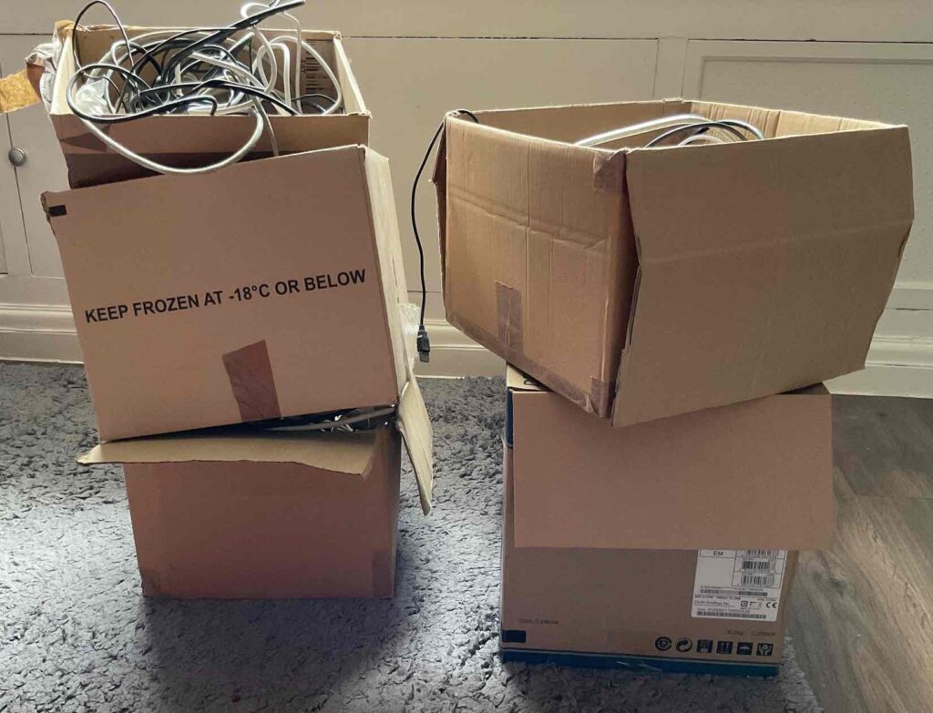 four cardboard boxes contains various wires - mostly with redundant connectors
