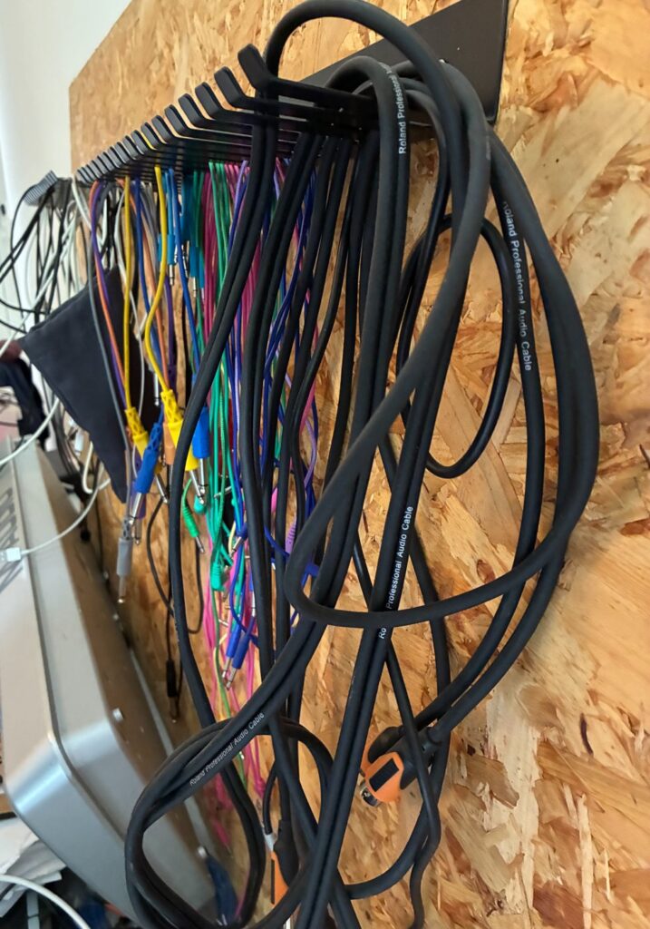 Rack of hanging assorted cables 